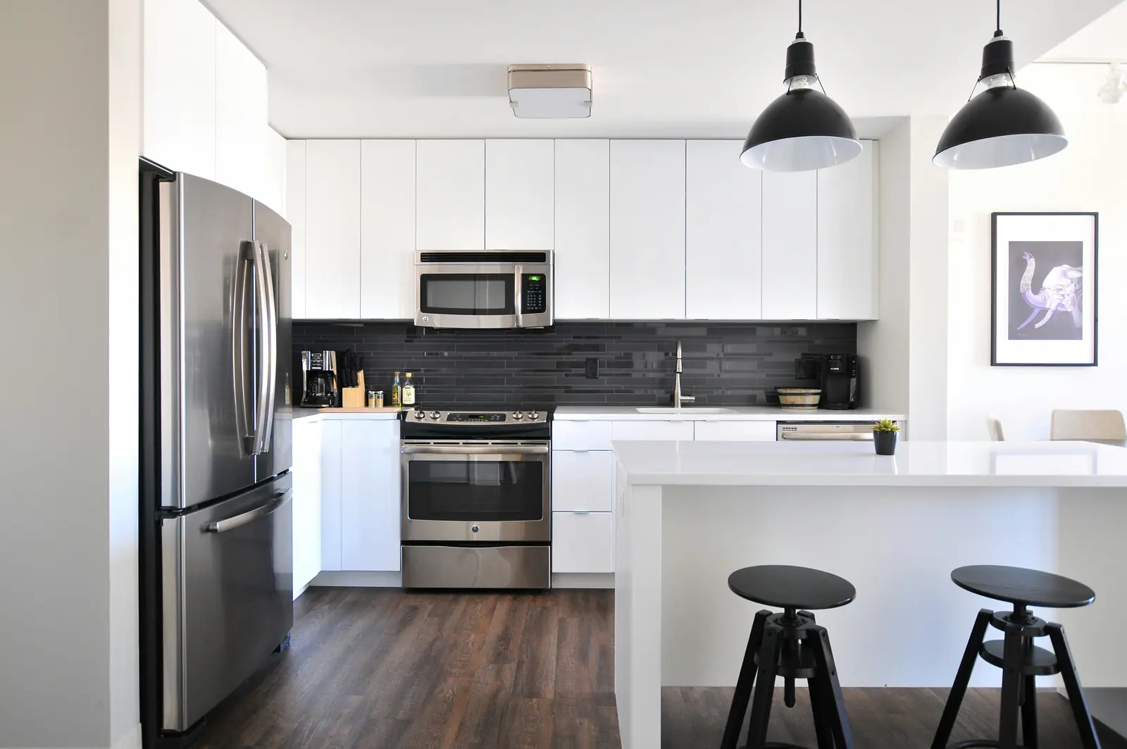 Bright modern kitchen with a stainless steel refrigerator and range