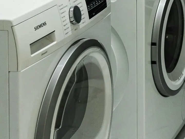 Laundry room dryer with lint screen and exterior vent maintenance reminders